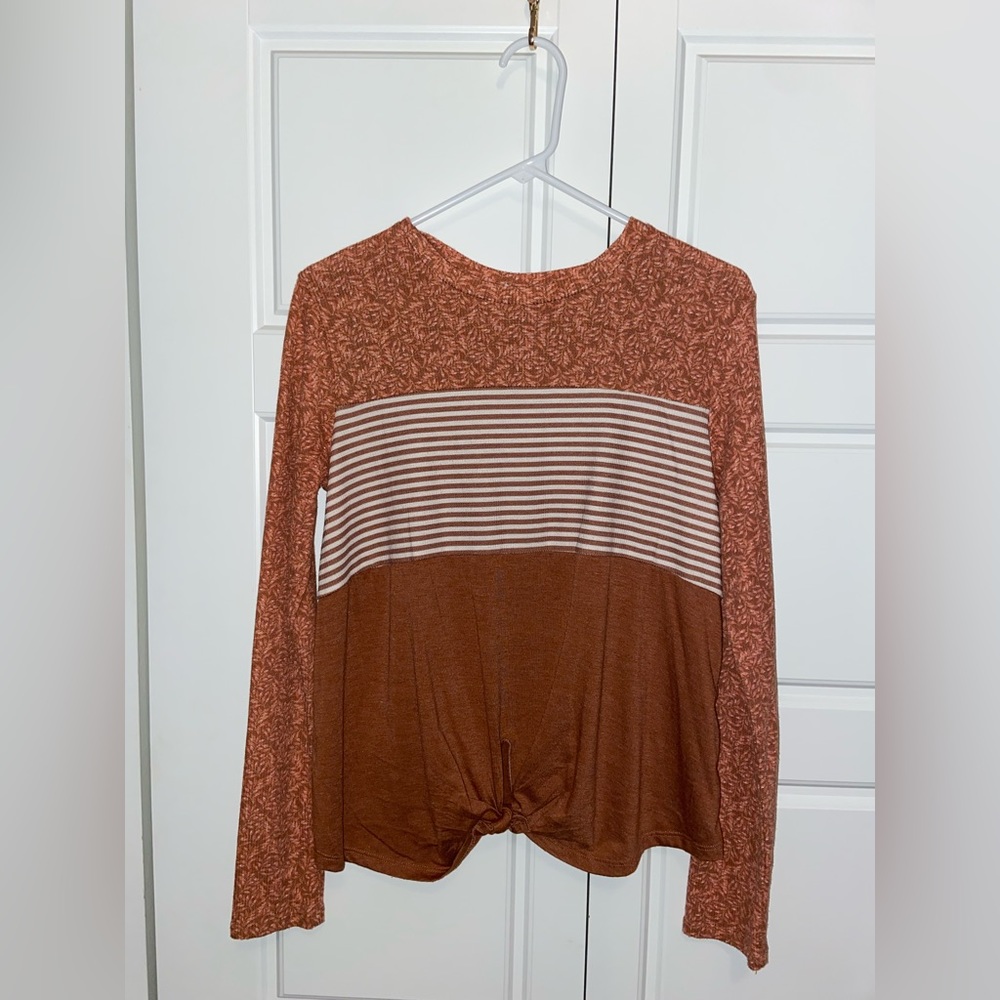 This is a thin medium sized shirt, perfect for a fall day!